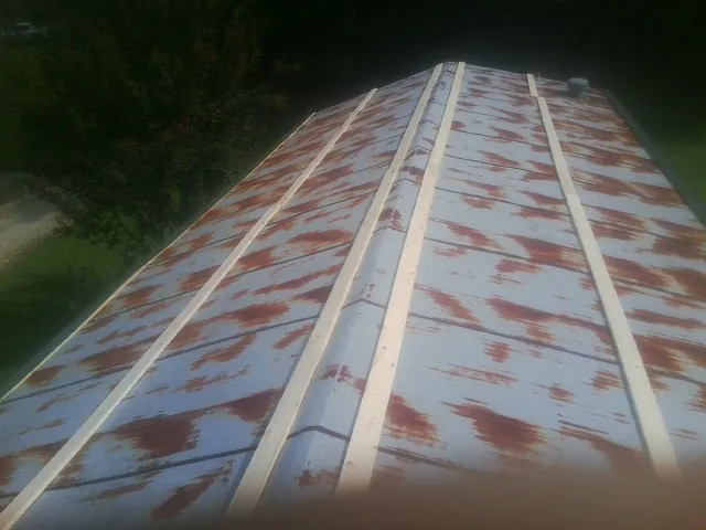 Rusted metal roof panels with new wood purlins before replacement — Storm Damage Roof Repair in Pilot Point by Roofing Brothers